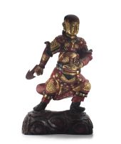 A Chinese lacquered wood and gilt temple guardian