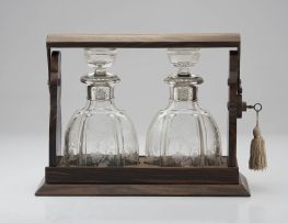 A French rosewood tantalus, fitted with a pair of silver-mounted glass decanters, Lagarde & Fortin, Paris (1922-28) .950 standard