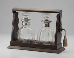 A French rosewood tantalus, fitted with a pair of silver-mounted glass decanters, Lagarde & Fortin, Paris (1922-28) .950 standard
