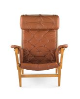 A Bruno Mathsson Pernilla beech plywood and brown leather upholstered armchair, designed in 1944, manufactured by Dux, Sweden, 1960s