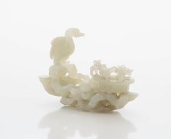 A Chinese pale celadon jade carving of a crane, Qing Dynasty, 19th century