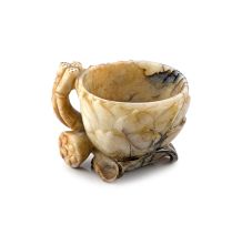 A Chinese grey and beige jade ‘lotus’ libation cup, Qing Dynasty, 19th century