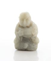 A Chinese grey jade figure of a monk holding a carp, Qing Dynasty, late 19th century