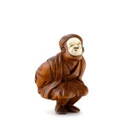 A wood and ivory netsuke of a Kyogen dancer, 19th century