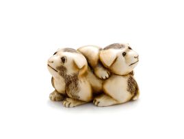 An ivory netsuke of two puppies playing, 19th century