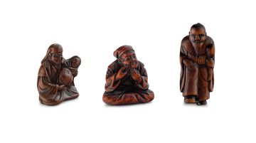 A Japanese wood netsuke of a father and baby, 19th century