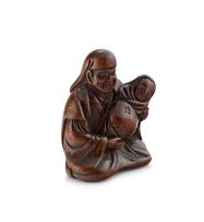 A Japanese wood netsuke of a father and baby, 19th century