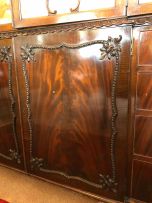 A Chippendale style flame mahogany breakfront bookcase, early 20th century