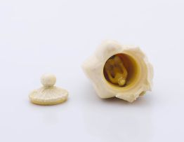 A Japanese ivory carving of a covered cantaloupe