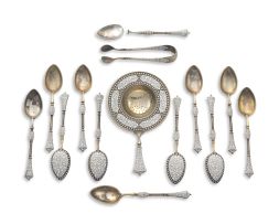 A set of Norwegian silver-gilt and white enamel teaspoons, a strainer and a pair of sugar nips, with import marks for Birmingham, 1901-1903