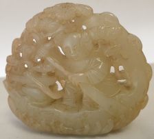 A Chinese jade pierced carving of a small boy in his boat