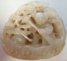 A Chinese jade pierced carving of a small boy in his boat
