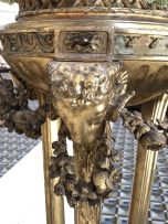 A George III giltwood tripod torchere