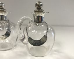 A pair of George V silver-mounted glass toddy measures and labels, Levi & Salaman, Birmingham, 1910