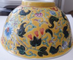 A pair of Chinese yellow ground famille-rose bowls