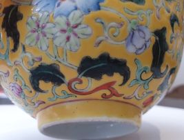 A pair of Chinese yellow ground famille-rose bowls