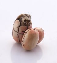 A Japanese stained ivory okimono netsuke of three owl's eggs