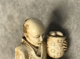 A Japanese ivory okimono figural group, Meiji period, 1868-1912