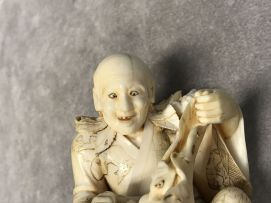 A Japanese carved ivory figure of a fisherman, Meiji period, 1868-1912