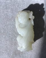 A Chinese celadon jade figure of a boy, Qing Dynasty, 19th century