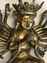 A Chinese gilt-bronze multi-armed figure of Guanyin, 17th century