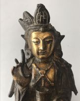 A Chinese parcel-gilt bronze figure of Guanyin, Ming Dynasty, 1636-1644