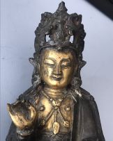 A Chinese parcel-gilt bronze figure of Guanyin, Ming Dynasty, 1636-1644