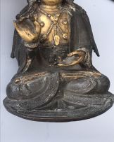 A Chinese parcel-gilt bronze figure of Guanyin, Ming Dynasty, 1636-1644