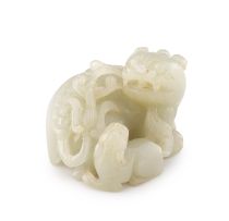 A Chinese celadon jade carving of a Buddhist lion and its pup, Qing Dynasty, 19th century