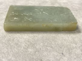 A Chinese celadon jade pendant, Qing Dynasty, 19th century