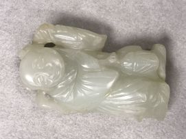 A Chinese celadon jade figure of a small boy, Qing Dynasty, 19th century