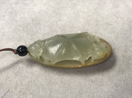 A Chinese celadon jade pendant, Qing Dynasty, 19th century