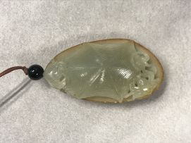 A Chinese celadon jade pendant, Qing Dynasty, 19th century