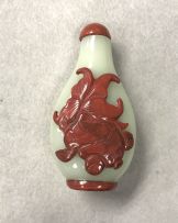 A rare Chinese celadon glass and cinnabar red overlay snuff bottle, Qing Dynasty, 18th/19th century