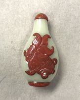 A rare Chinese celadon glass and cinnabar red overlay snuff bottle, Qing Dynasty, 18th/19th century