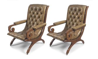 A pair of walnut and leather-upholstered armchairs, late 19th century