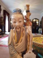 A Chinese stained ivory carved figure of a gardener, 20th century