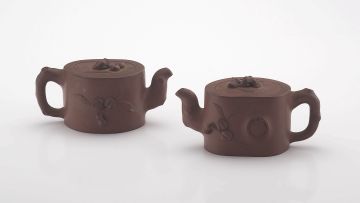 A pair of Chinese Yixing miniature teapots