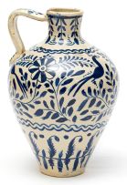 Unknown; Blue and white 'Isnic' style vessel, the ovoid body painted with stylized birds flanking foliate sprays above a double-wave and foliate border. The shoulder applied with a strap handle.