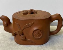 A pair of Chinese Yixing miniature teapots