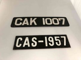 A black and white painted steel vehicle registration number plate CAK 1007