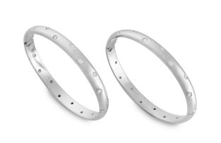 A pair of diamond and white gold bangles