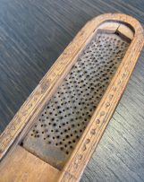 A treen fruitwood nutmeg grater, 19th century