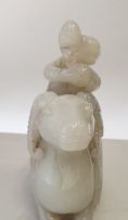 A Chinese carved jade figure of a small boy astride a ram, 19th century