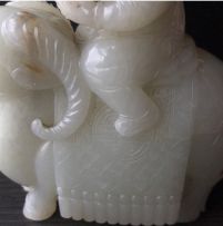 A Chinese carved jade figure of a small boy astride a ram, 19th century
