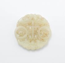 A Chinese celadon jade disc, Qing Dynasty, 19th century
