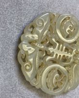 A Chinese celadon jade disc, Qing Dynasty, 19th century