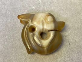 A Chinese Archaic carved agate pendant of a Zhulong
