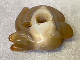 A Chinese Archaic carved agate pendant of a Zhulong