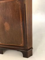 An Edwardian mahogany and inlaid corner cupboard